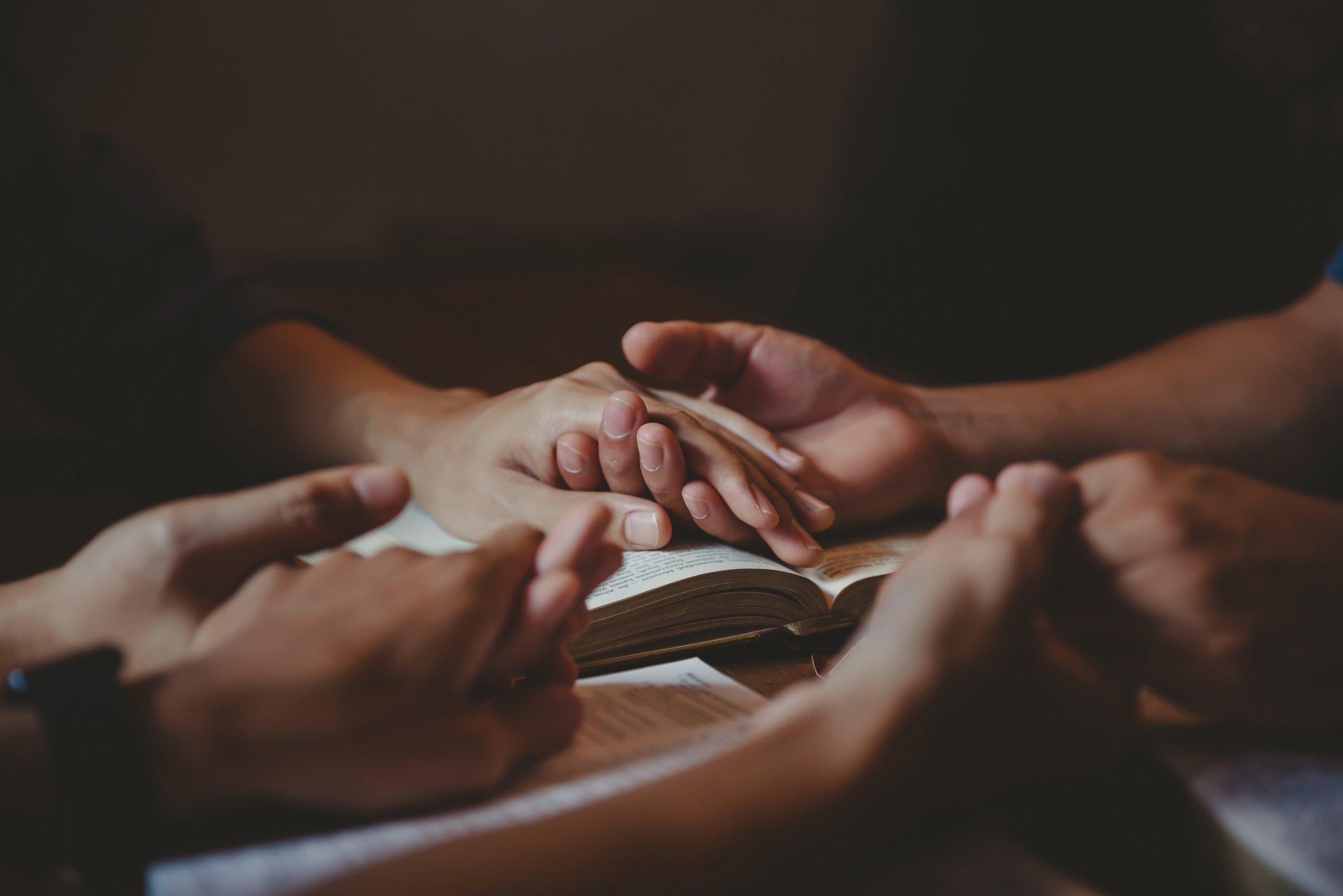 Christian group are praying to god with the bible