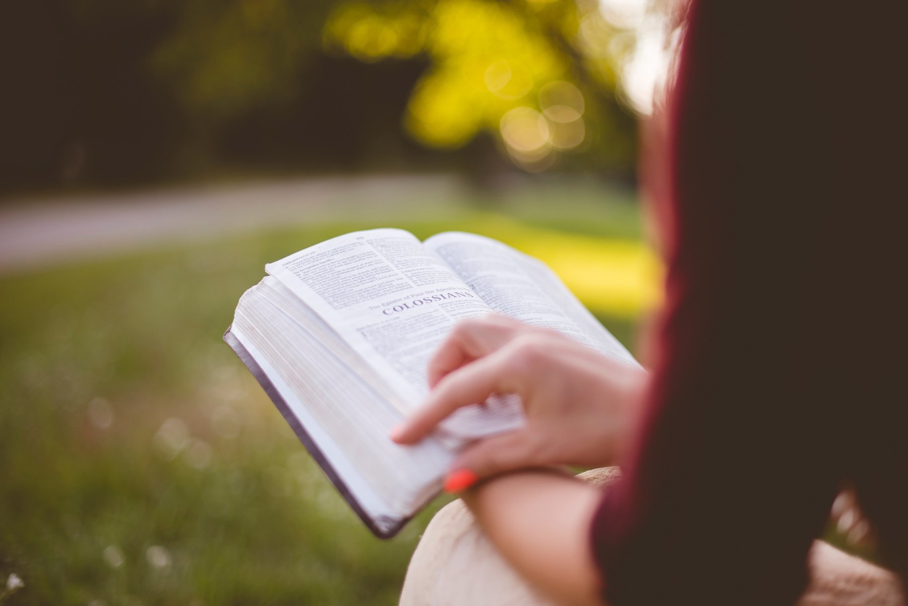 Woman Reading a Bible Outdoors